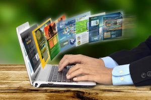 A man types on his laptop